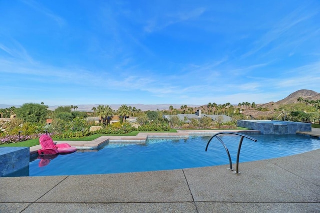 view of swimming pool with a mountain view