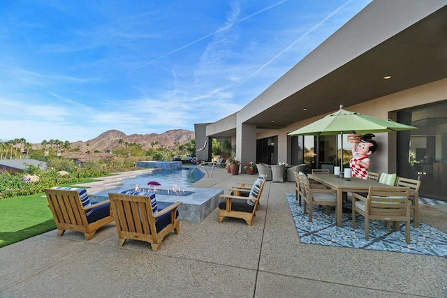 view of swimming pool featuring an outdoor fire pit, a mountain view, and a patio area