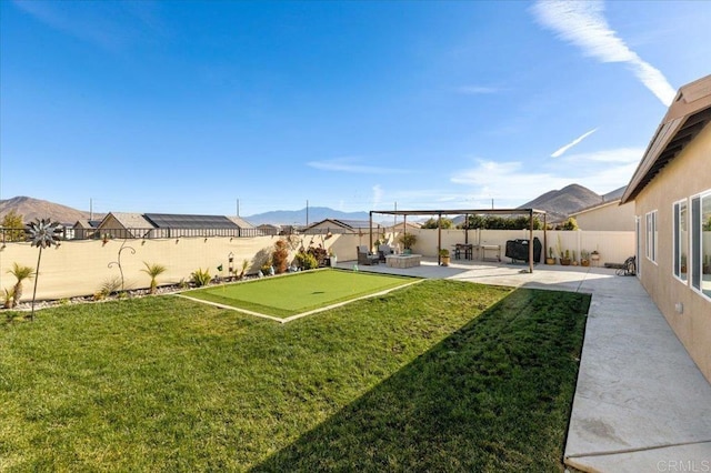 view of yard featuring a patio and a mountain view