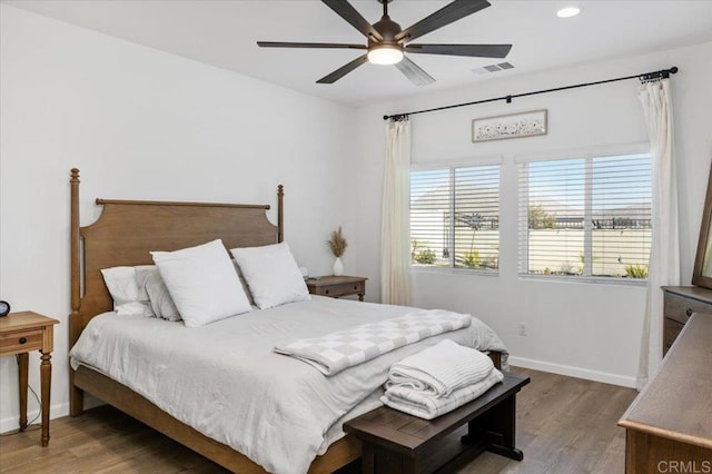 bedroom with ceiling fan and wood-type flooring