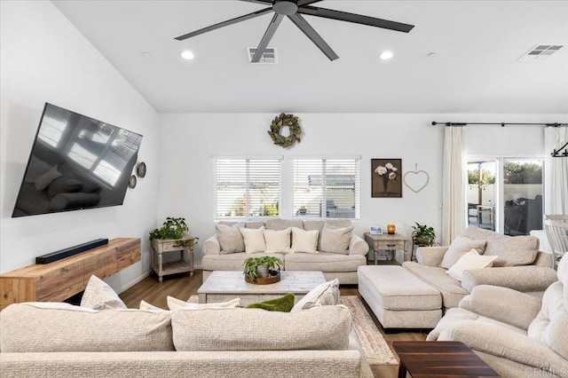 living room featuring hardwood / wood-style flooring, plenty of natural light, lofted ceiling, and ceiling fan