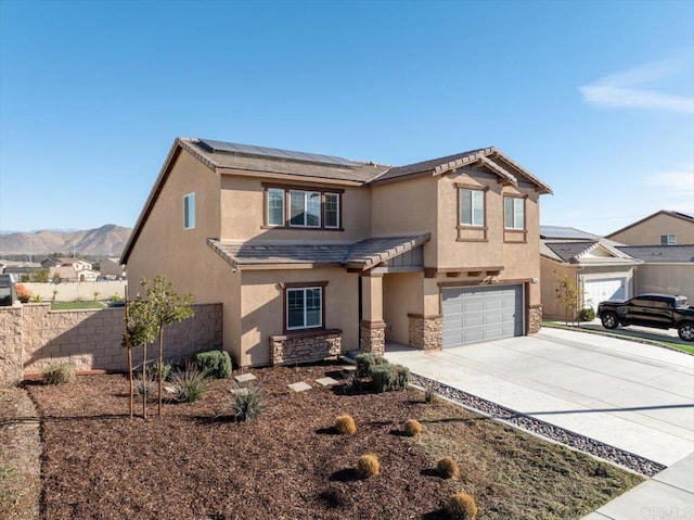 view of front of property featuring a garage and a mountain view