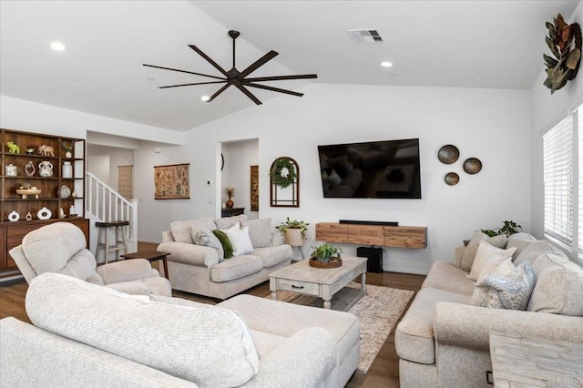 living room featuring vaulted ceiling, ceiling fan, a fireplace, and hardwood / wood-style floors