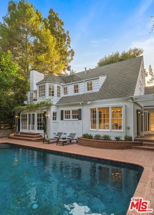 rear view of property with a patio area and french doors