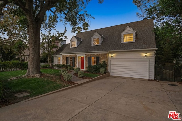 new england style home featuring a garage