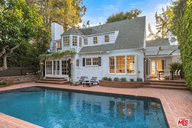 rear view of house featuring a patio, a pergola, and french doors