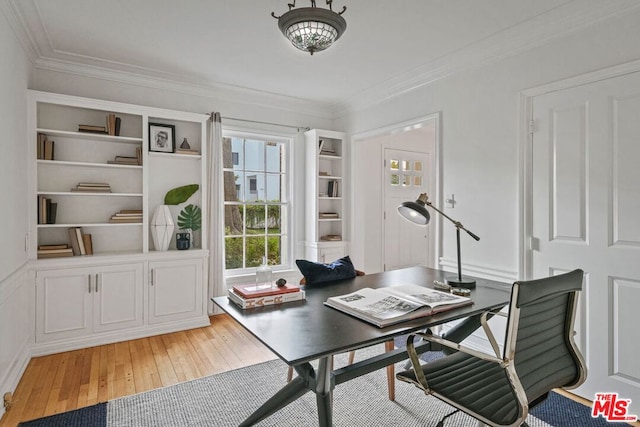 office featuring built in shelves, ornamental molding, and hardwood / wood-style floors