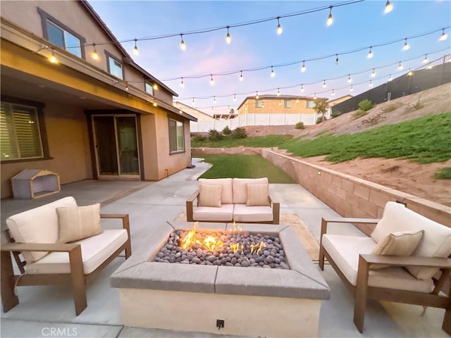 patio terrace at dusk featuring an outdoor living space with a fire pit