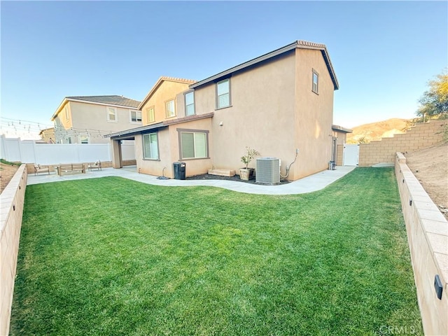 back of property featuring a patio area, central AC unit, and a lawn