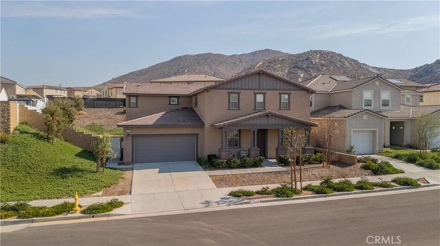 view of front of property with a garage and a mountain view