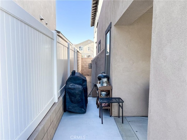 view of property exterior with a patio area