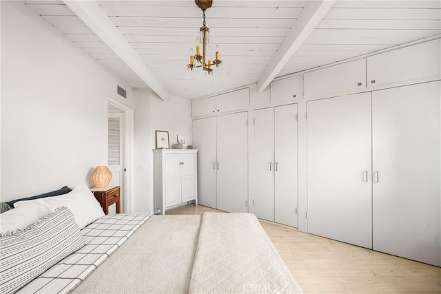 unfurnished bedroom featuring wood ceiling, an inviting chandelier, multiple closets, beam ceiling, and light hardwood / wood-style floors