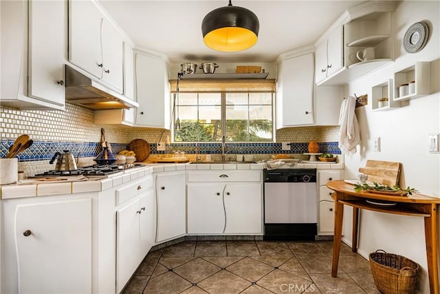 kitchen featuring sink, tile counters, stainless steel appliances, and white cabinets