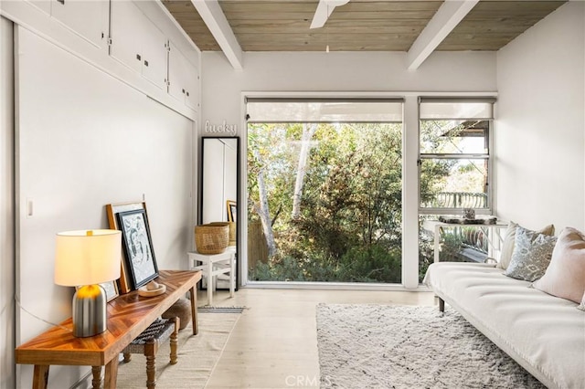 sitting room featuring beam ceiling, plenty of natural light, and wooden ceiling