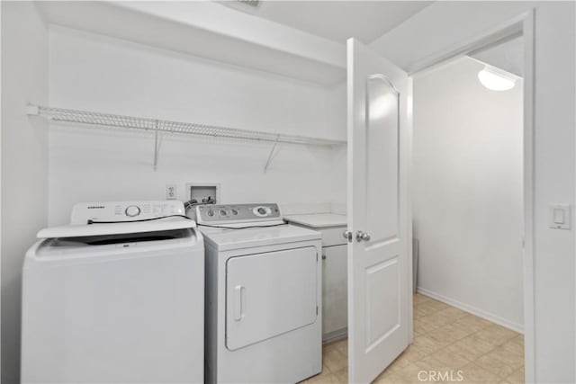 clothes washing area with washing machine and dryer