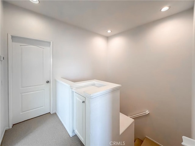 clothes washing area featuring light colored carpet