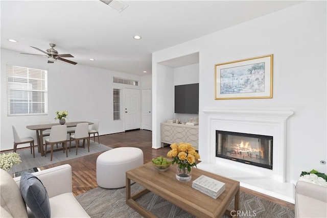 living room featuring dark hardwood / wood-style floors and ceiling fan