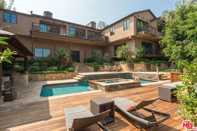 view of pool featuring an in ground hot tub and a wooden deck