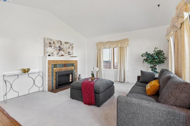 carpeted living room featuring lofted ceiling and a fireplace