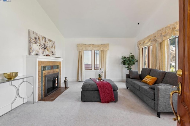 living room featuring lofted ceiling, carpet floors, and a healthy amount of sunlight