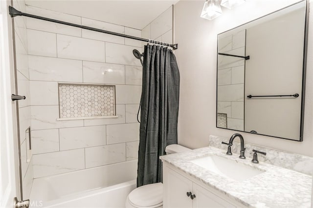 full bathroom with shower / bath combo, vanity, and toilet