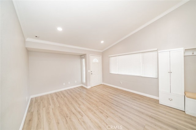 unfurnished room featuring ornamental molding, vaulted ceiling, and light wood-type flooring