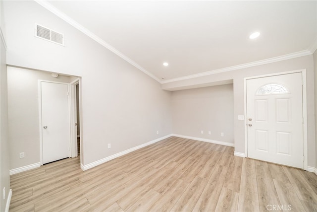 foyer entrance with crown molding and light hardwood / wood-style flooring