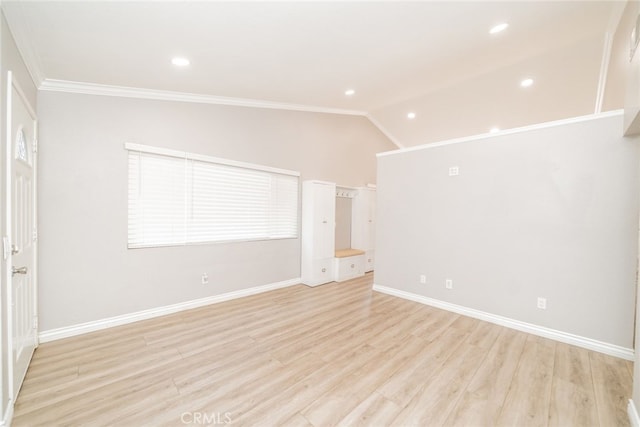 interior space featuring lofted ceiling, crown molding, and light hardwood / wood-style flooring