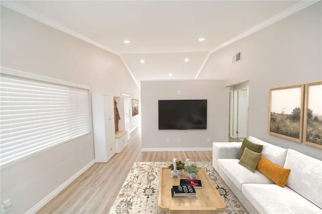 living room featuring crown molding, light hardwood / wood-style flooring, and vaulted ceiling