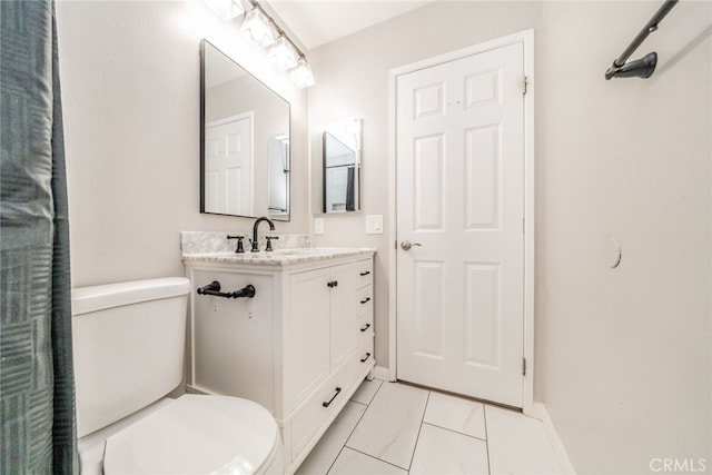 bathroom with vanity, tile patterned floors, and toilet