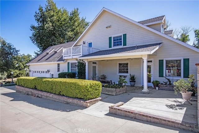 view of front of property with a balcony and a garage