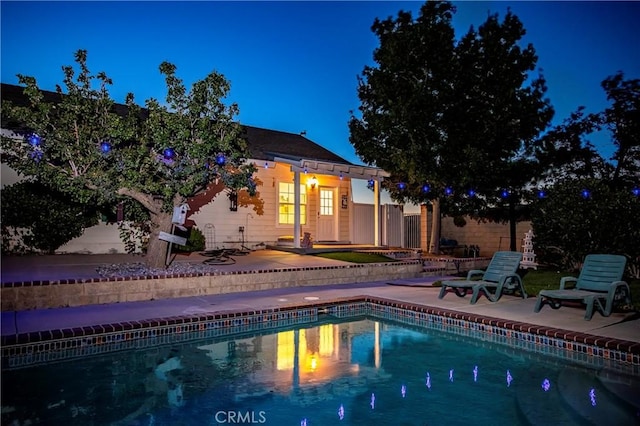 view of swimming pool featuring an outdoor structure and a patio area