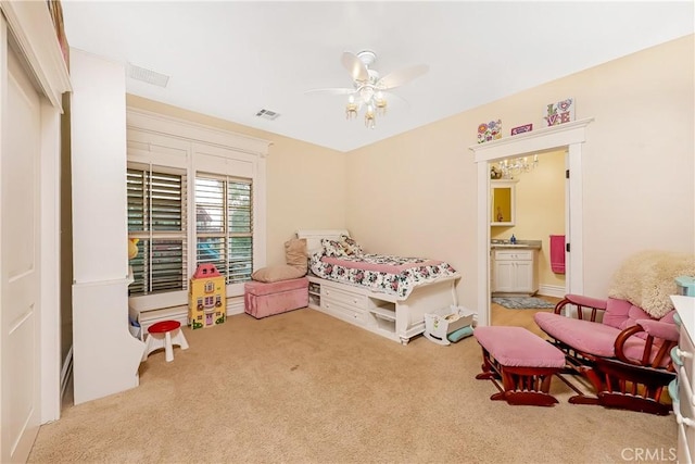 carpeted bedroom featuring connected bathroom and ceiling fan