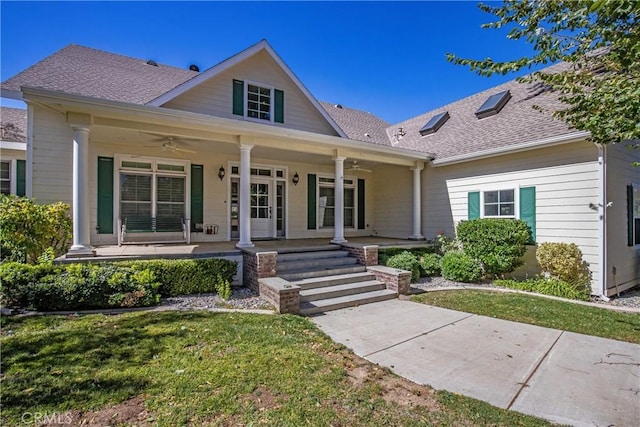 view of front of house with a porch, a front yard, and ceiling fan