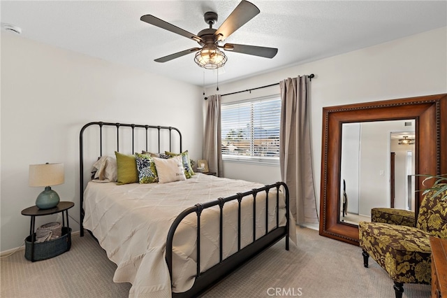 bedroom with light carpet, a ceiling fan, and baseboards