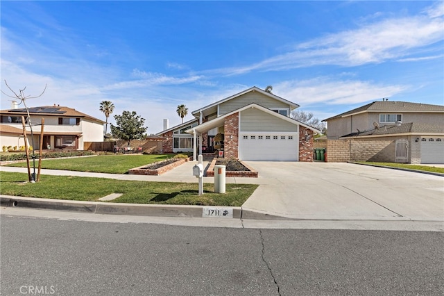 view of front of house with an attached garage, brick siding, driveway, a residential view, and a front yard