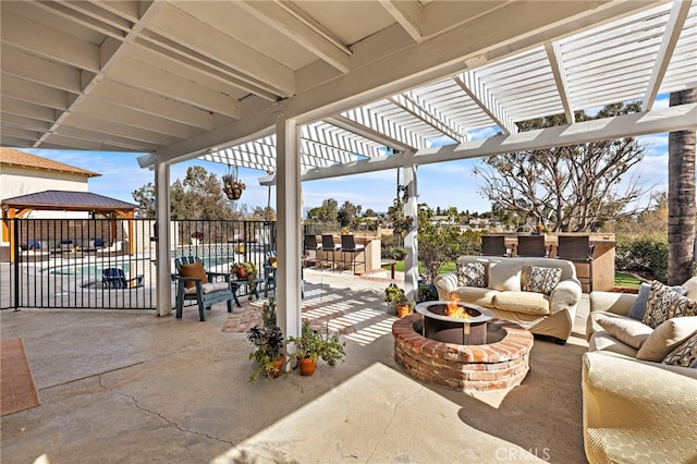 view of patio with an outdoor living space with a fire pit, fence, and a pergola