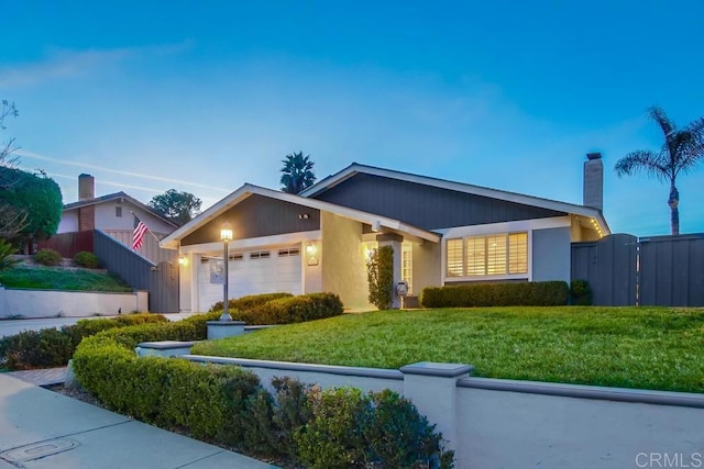 view of front of property with a garage and a front lawn