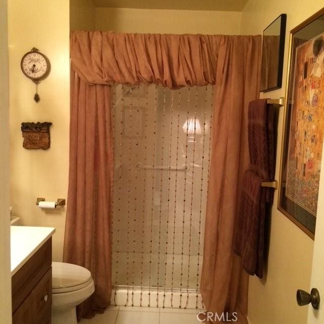 bathroom featuring vanity, tile patterned floors, and toilet