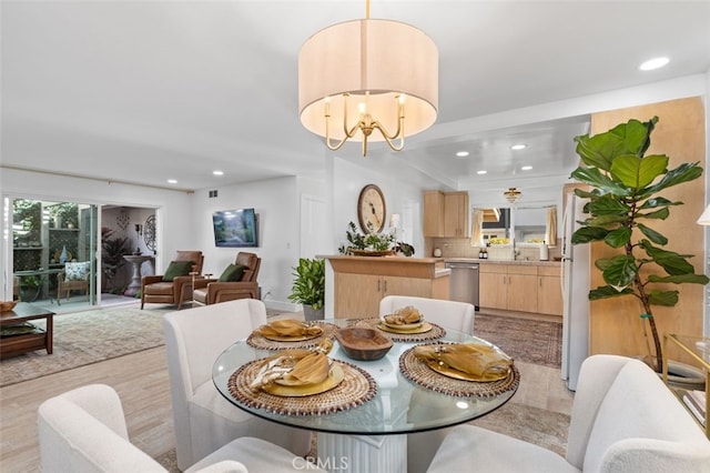 dining area featuring a chandelier and light wood-type flooring