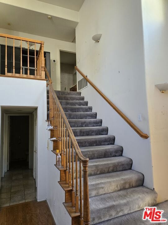 staircase with wood-type flooring