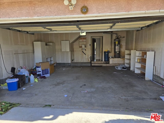 garage with a garage door opener and gas water heater