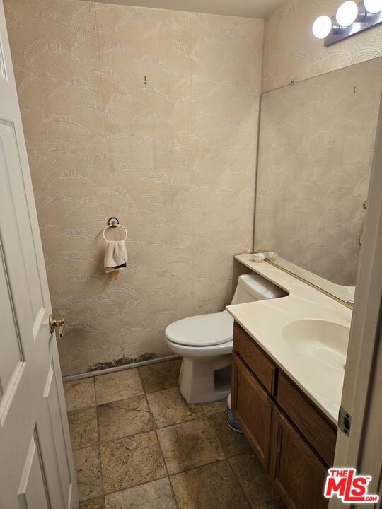 bathroom featuring vanity and toilet