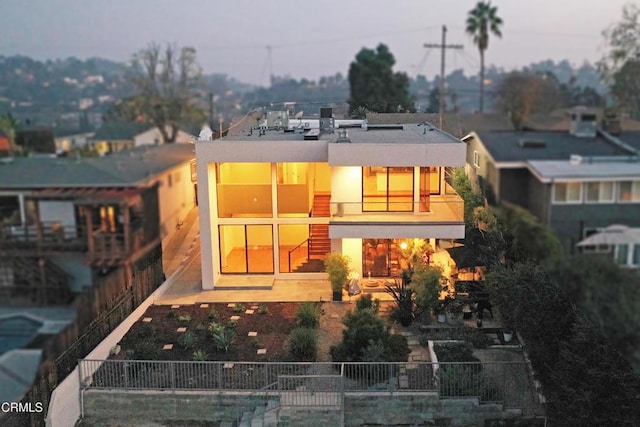 rear view of property with a patio and a balcony