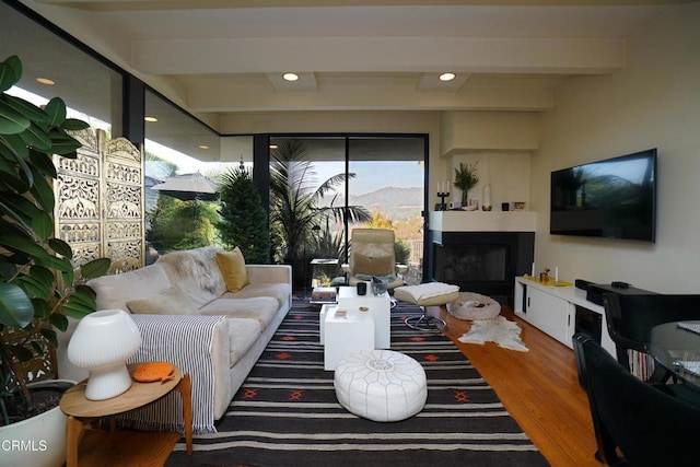 living room featuring hardwood / wood-style floors and beamed ceiling