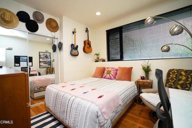 bedroom with dark wood-type flooring