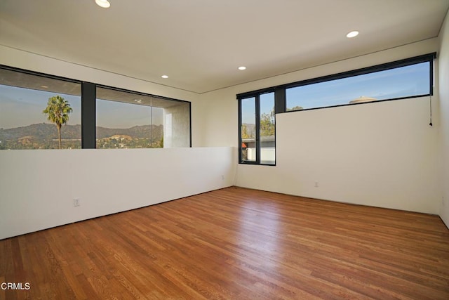 unfurnished room with hardwood / wood-style floors