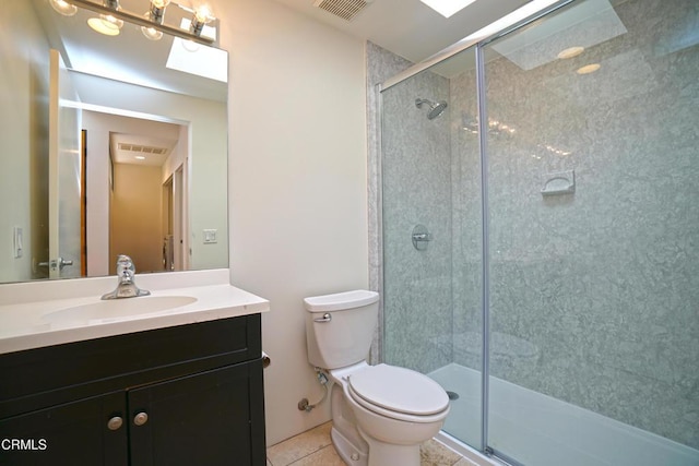 bathroom with vanity, a shower with shower door, tile patterned floors, and toilet