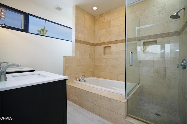 bathroom with independent shower and bath and vanity