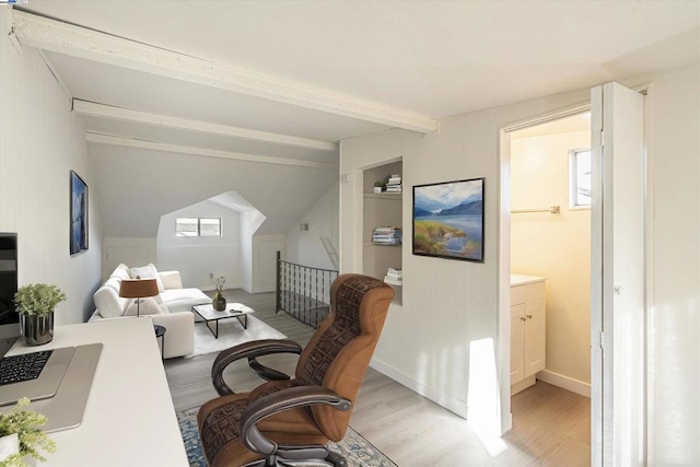 home office with vaulted ceiling with beams, light hardwood / wood-style flooring, and built in shelves